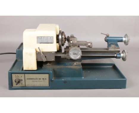 A Cowells Model 90 ME clock maker's table top centre lathe.  Tested and is in working order.