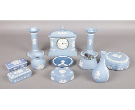 A quantity of Wedgwood Jasperware ceramics. To include a pair of candlesticks, Ronson desktop lighter, trinket boxes and cloc
