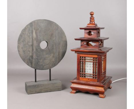 A wooden oriental temple table light with wooden circular sculpture. Lamp H:47cm W: 20cm.  Light in working order.