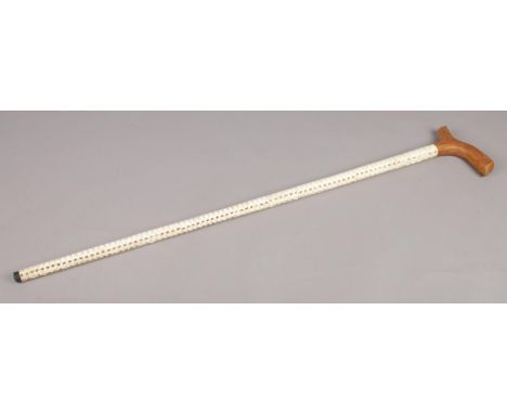 A walking stick in the form of vertebrae, with wooden handle. 89cm long.  Crack to one vertebra.