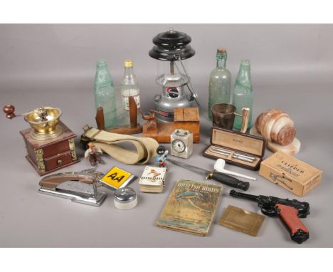 A quantity of collectables. Including commando knife, Military belt, Parker pens, glass bottles, Coleman lamp, etc.  