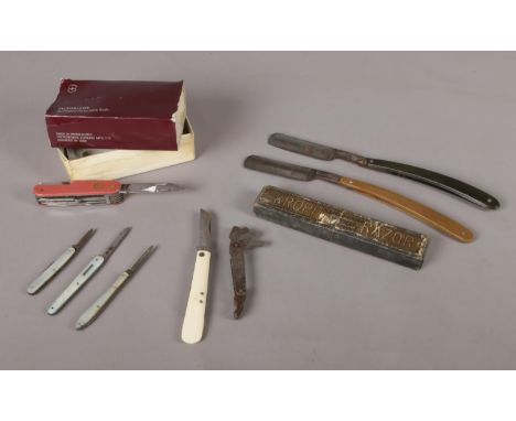 An assortment of pen knives and razors. To include two Kropp cut throat razors (one boxed), three small pen knives with mothe