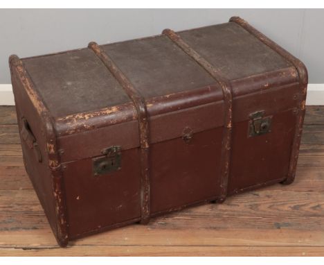 A vintage travel trunk with wooden bounding.  