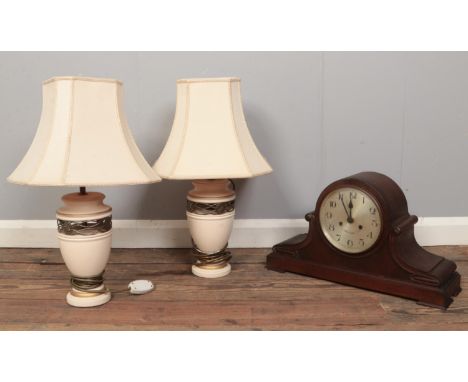A pair of ceramic table lamps and shades along with a dome shaped mantel clock.  