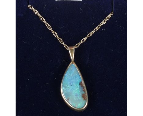A silver gilt matrix opal pendant on 9ct gold chain.  