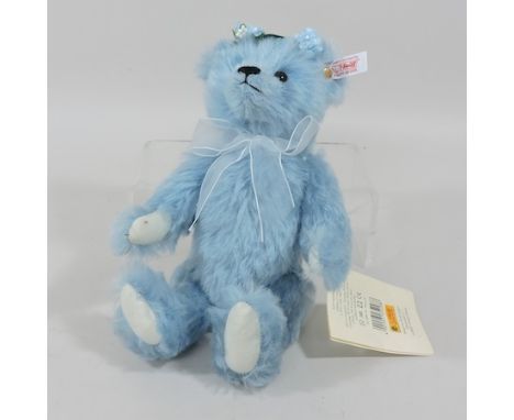 A modern blue Steiff teddy bear, 26cm tall