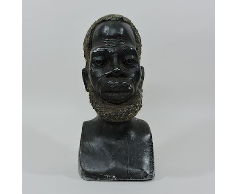 An African carved stone portrait bust of a tribesman, 32cm tall