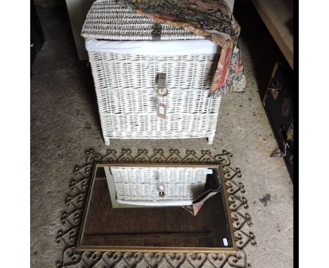 A white painted wicker hamper, together with a metal framed wall mirror and a tapestry wall hanging