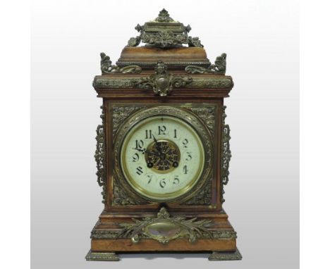 An early 20th century continental walnut and gilt metal mounted bracket clock, with an enamel dial and twin train movement st