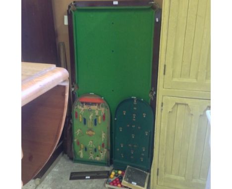 An early 20th century table top snooker table, 159 x 82cm, together with a bagatelle and other games