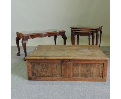 A 1920's carved walnut coffee table, 91cm, together with a matching nest of three tables and an oak trunk