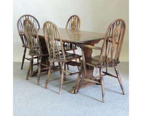 A 1960's Ercol dark elm refectory table, 151 x 76cm, together with a set of five wheel back dining chairs