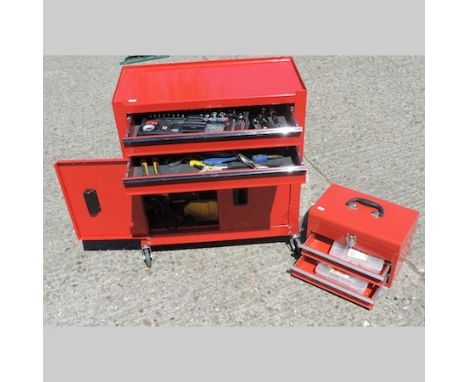 A red painted tool cabinet, 62cm, containing a JCB electric saw, various adjustable spanners and a part socket set, together 