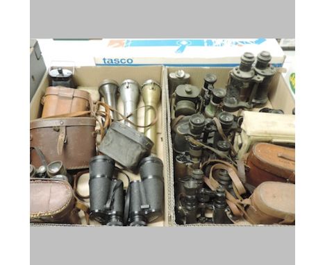 A collection of military related items to include torches, lamps and field binoculars, together with a Tasco telescope