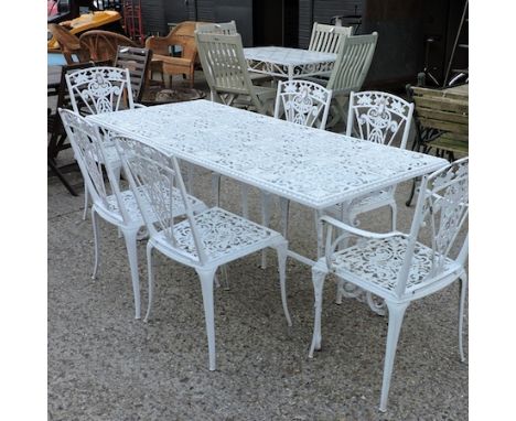 A white painted metal garden table, together with a set of six matching dining chairs, to include an armchair