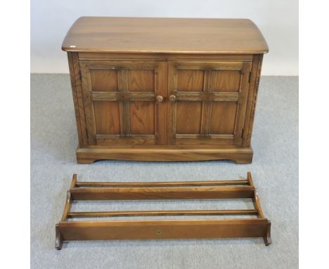 An Ercol medium elm cabinet, 102cm together with an Ercol plate rack