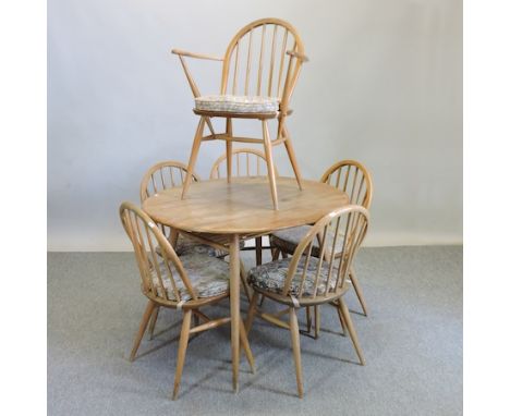 A 1970's Ercol light elm circular dining table, 91cm together with a set of six matching spindle back dining chairs