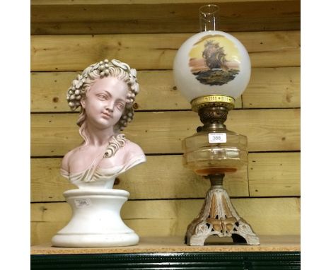 An early 20th century oil lamp, with a painted glass shade, together with a painted portrait bust,  44cm tall 