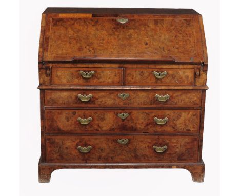 A George II burr walnut bureau, circa 1740  A George II burr walnut bureau,   circa 1740, the hinged rectangular fall opening