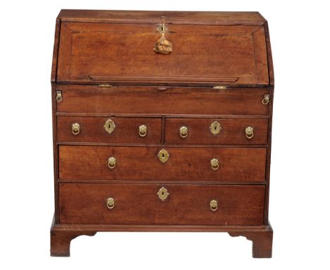 A George II walnut bureau , circa 1735, the sloping fall enclosing an...  A George II walnut bureau  , circa 1735 ,   the slo