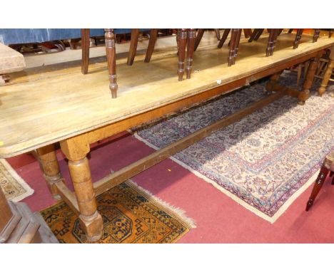 An extremely long rustic light oak plank top round cornered school hall mess table, raised on ring-turned and square cut supp