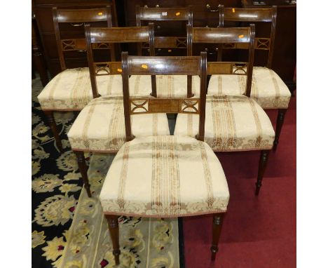 A set of six Regency mahogany and ebony strung barback dining chairs, each having floral striped upholstered stuffover seats,