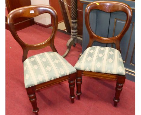 A set of four mahogany balloon back dining chairs, each having green striped silk fabric upholstered drop-in pad seats and on