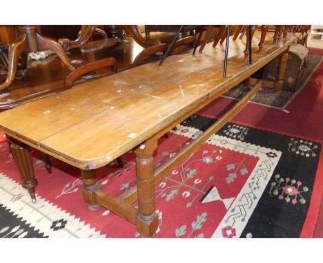 An extremely long rustic light oak plank top round cornered school hall mess table, raised on ring-turned and square cut supp