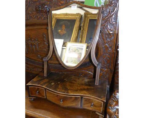 An Edwardian mahogany and flame mahogany shield shaped dressing mirror, on serpentine three drawer boxbase; together with a l