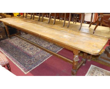 An extremely long rustic light oak plank top round cornered school hall mess table, raised on ring-turned and square cut supp