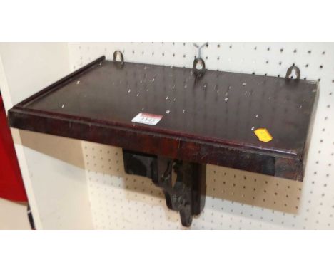An early 20th century walnut wall bracket, with pierced floral supporting detail (some losses and damages), width 36.5cm