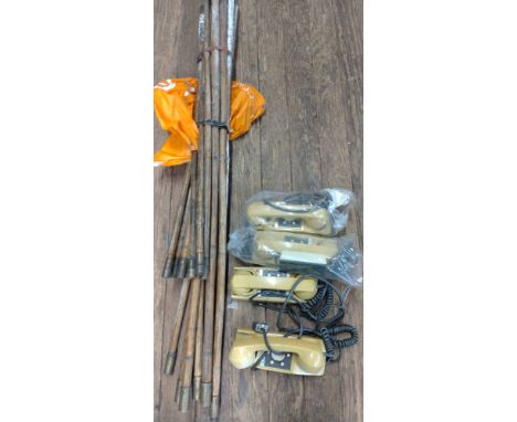 A box of vintage telephones and a set of chimney sweep brushes. 