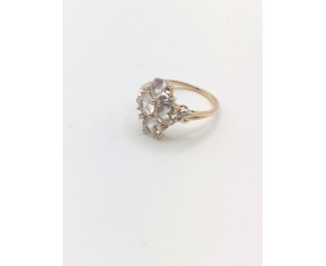 A 9ct yellow gold and CZ ring, set with four mixed round-cut stones, with small diamond accents, size O, 2.8 grams. 