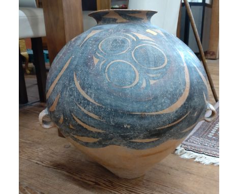 A Chinese 'Banshan' type pottery storage jar, in the Neolithic style, with typical black pigment decoration, twin handled. 