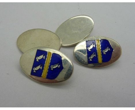 A pair of silver and enamel cufflinks