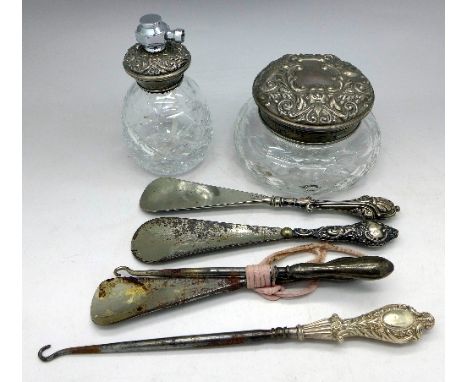 A silver topped glass jar, an atomiser, three shoe horns and two button hooks