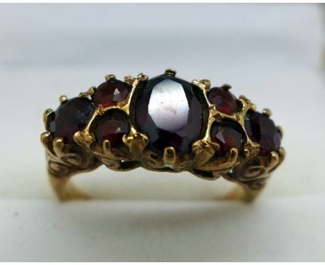 A 9ct gold ring set with seven garnets, weight 3.2g, size J