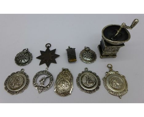 Eight fobs including sporting and a novelty white metal item