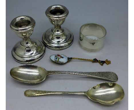 Silver including a napkin ring, Birmingham 1951, a pair of silver candlesticks, Birmingham 1967 and three silver spoons, weig