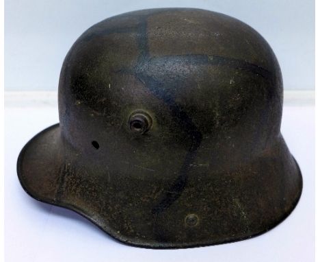 A German World War I steel helmet, M1916, BF64, F.C. Bellinger, Fulda, with original liner and camouflage paintwork, lacking 