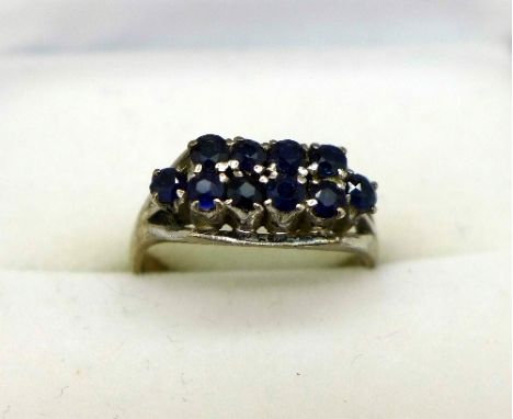 An 18ct white gold and sapphire ring set with ten sapphires, weight 2.6g, size I