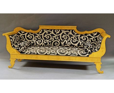 A large Biedermeier style birch wood scroll end sofa, 20th century, raised on scrolling legs, upholstered with black and whit