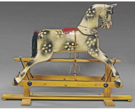 A child's rocking horse, 20th century, on pine support, the body with painted splashes, with leather harness and saddle patch