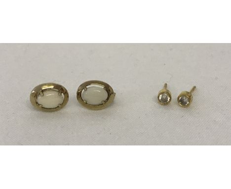 2 pairs of 9ct gold stud style earrings. A pair of oval cut opal stones in oval gold mounts. Together with a pair of small go