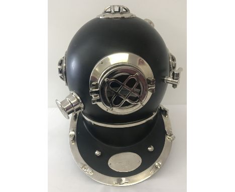 An ornamental black metal and chrome divers helmet. Marked "US Navy Diving Helmet Mark V, Morse Diving Equipment Co Inc.". Wi