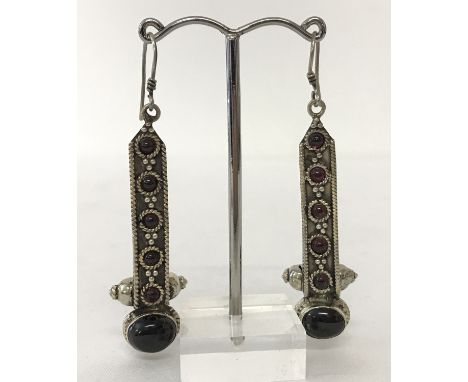 A pair of 925 silver drop earrings, each set with 6 garnet cabochons.  Approx. 5.5cm long.