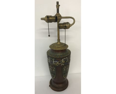 A vintage metal lamp base with cloisonné detail. Twin bulb fitment with pull style switches. On circular wooden plinth. Needs