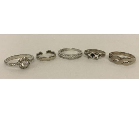 4 silver and white metal dress rings, some stone set, together with a wave design silver toe ring.  Sizes T, Q, R and N.