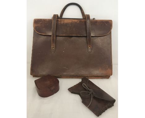 3 vintage leather items. A music satchel, a calf skin stud box and an axe head case.  