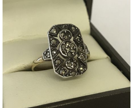 An Art Deco 9ct gold and silver vintage dress ring set with marcasite's. 2 stones missing. Size N½. Total weight approx. 3.7g